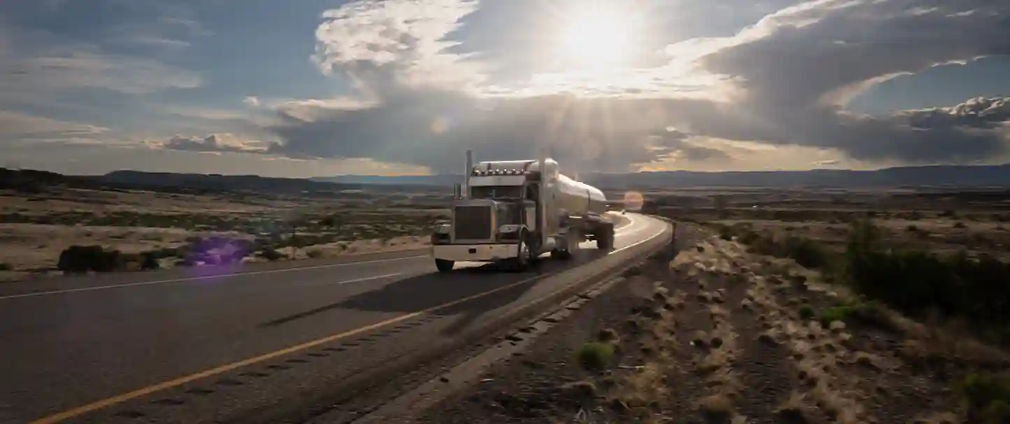A wide shot of a semi truck on the open road